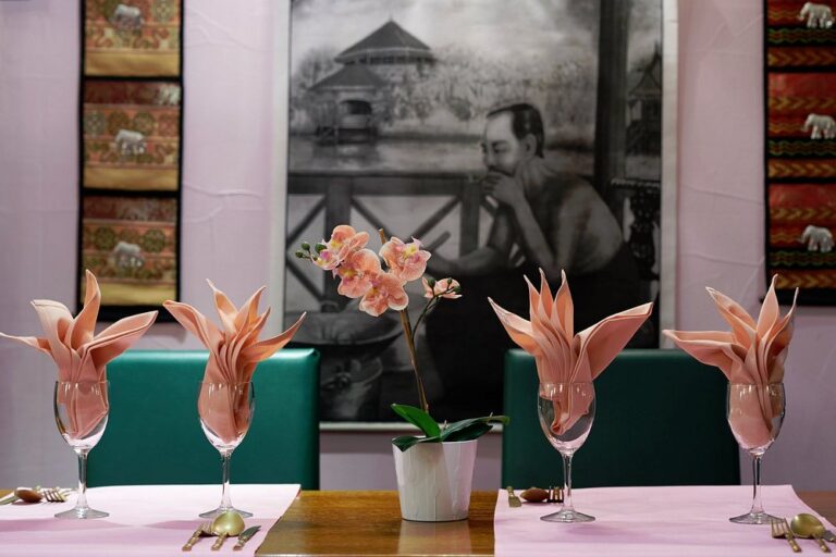 Tables laid with orchids in the Thai Orchid Battle dining room